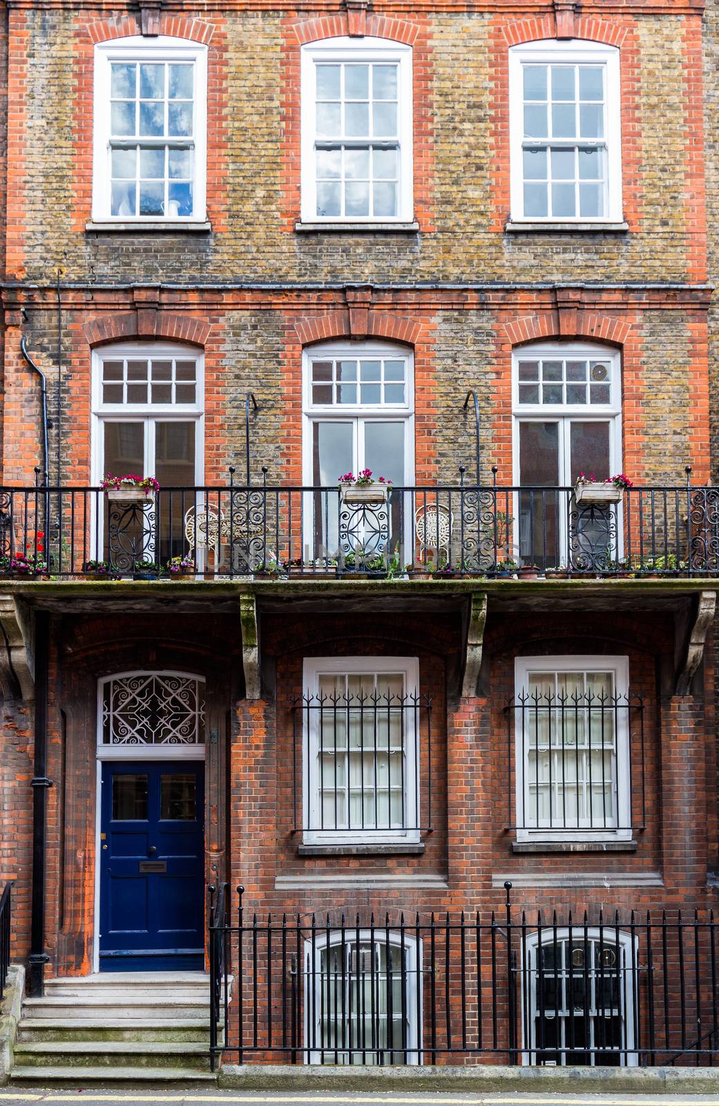 Typical street scene in the central London district with familiar architecture facades to urban housing.