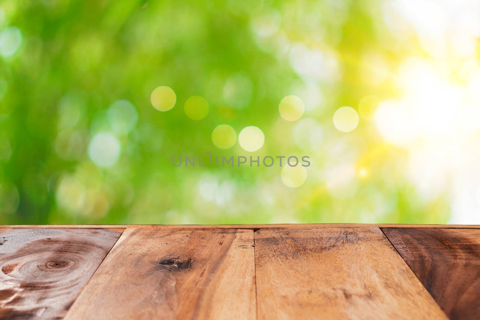 Selective focus of empty old wood on blur nature green leaf with bokeh abstract background.