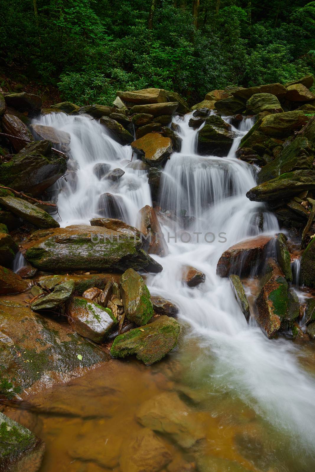 Waterfall pouring over rocks in Pisgah National Forest, NC.