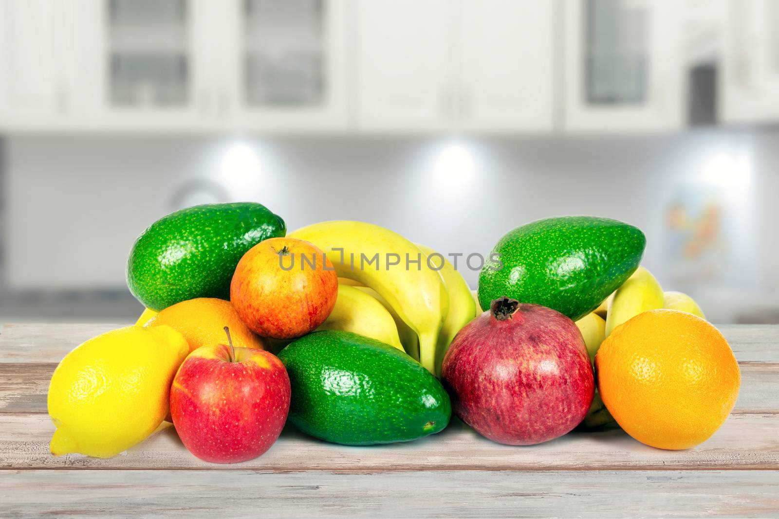 Healthy eating concept - group of various fruits on a wooden table in the kitchen in close-up