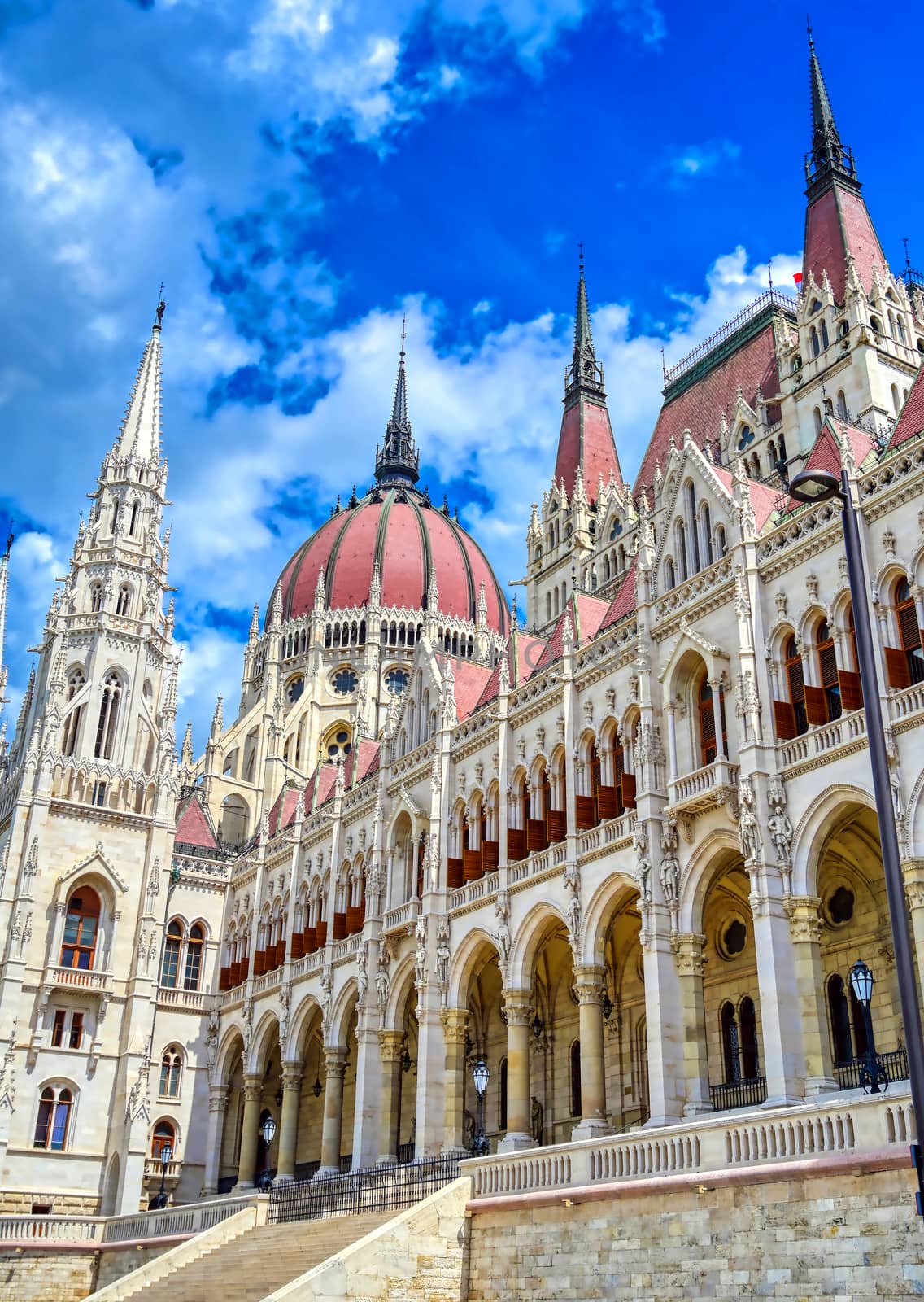 The Hungarian Parliament Building located on the Danube River in Budapest Hungary at sunset.