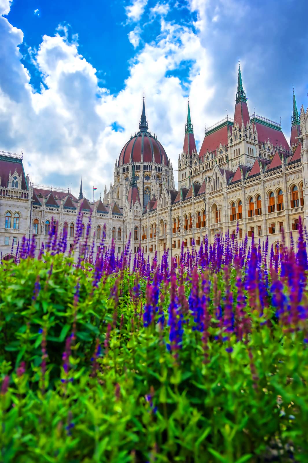 The Hungarian Parliament Building located on the Danube River in Budapest Hungary at sunset.