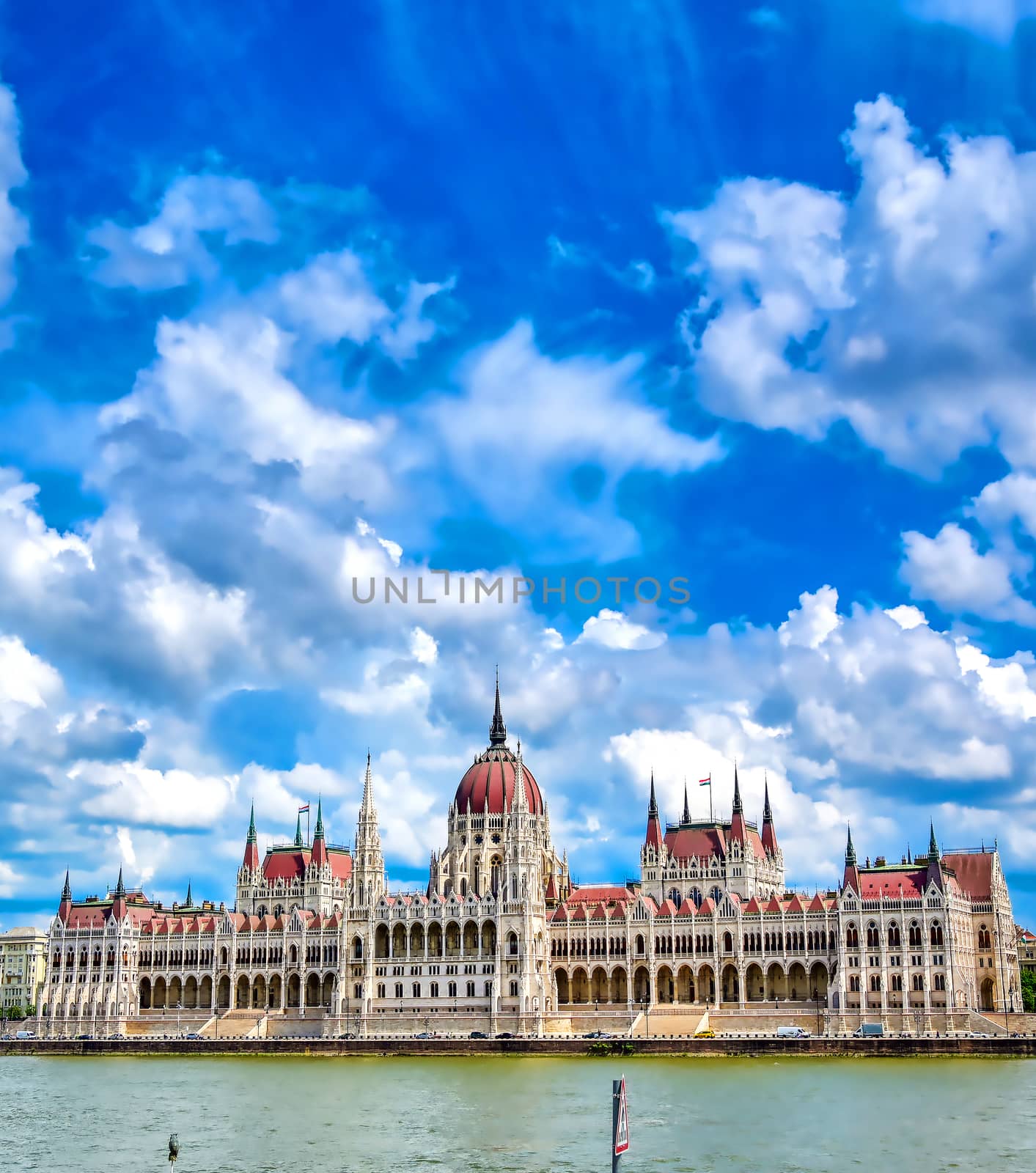 The Hungarian Parliament Building located on the Danube River in Budapest Hungary at sunset.