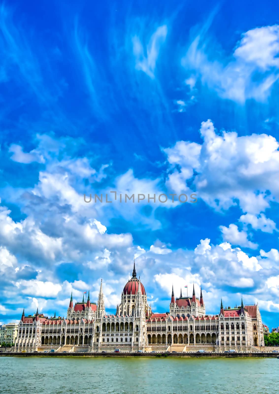 The Hungarian Parliament Building located on the Danube River in Budapest Hungary at sunset.