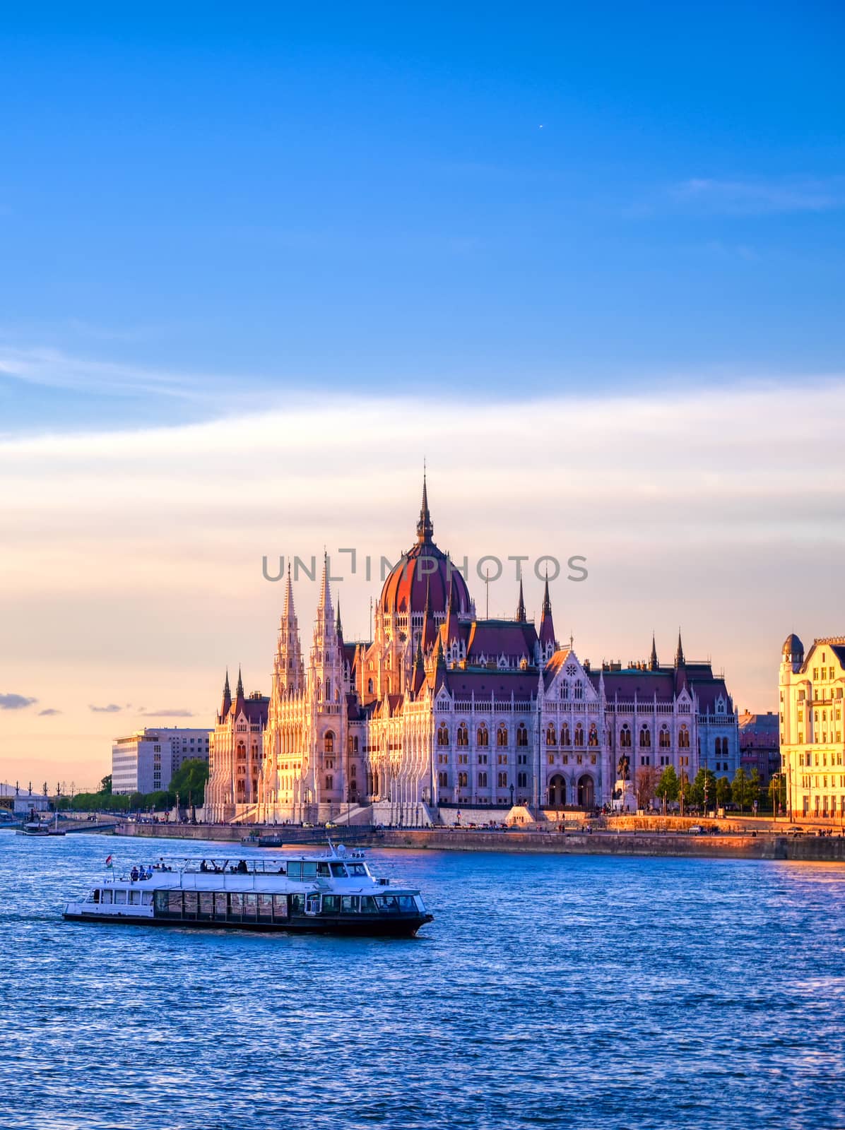 The Hungarian Parliament Building located on the Danube River in Budapest Hungary at sunset.