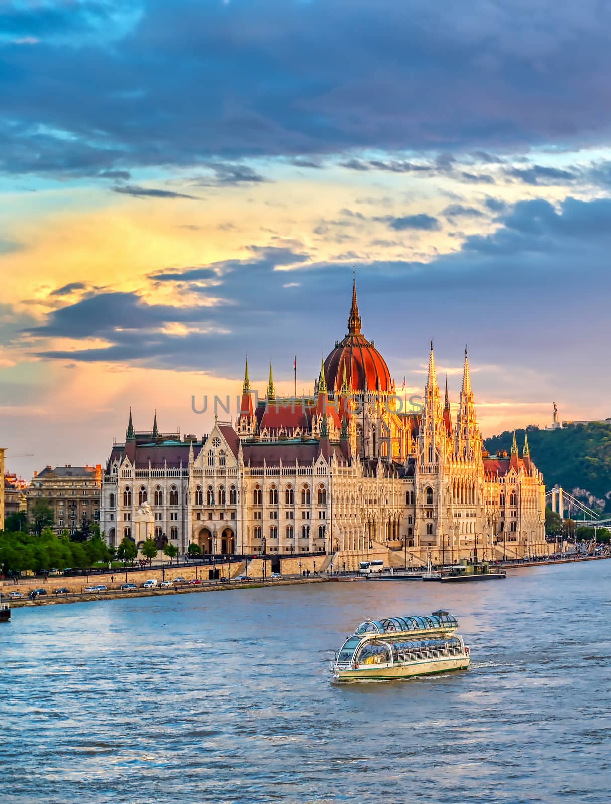 The Hungarian Parliament Building located on the Danube River in Budapest Hungary at sunset.