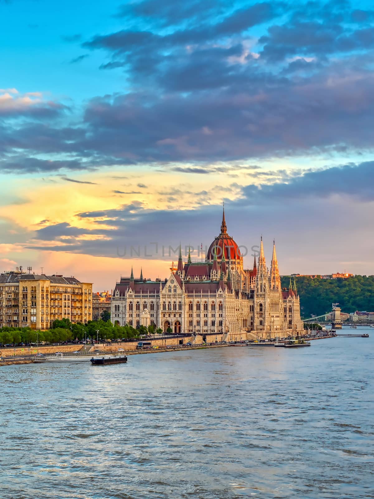 The Hungarian Parliament Building located on the Danube River in Budapest Hungary at sunset.