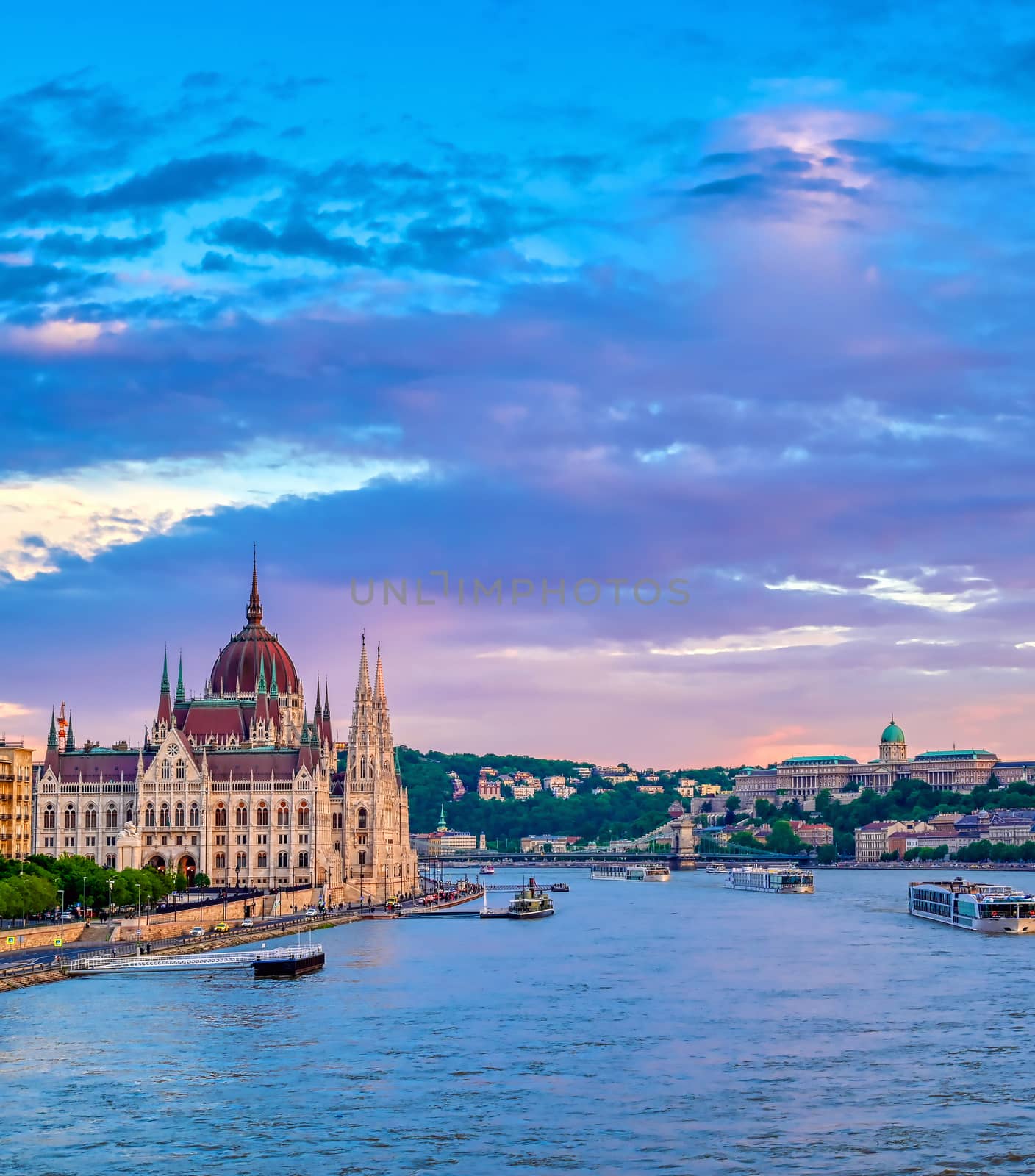 The Hungarian Parliament Building located on the Danube River in Budapest Hungary at sunset.