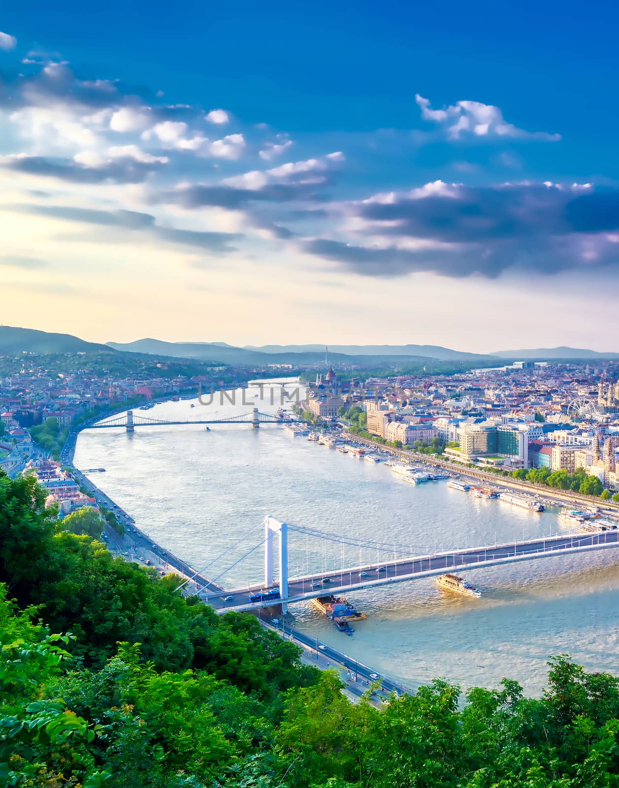 A view along the Danube River of Budapest, Hungary from Gellert Hill at sunset.