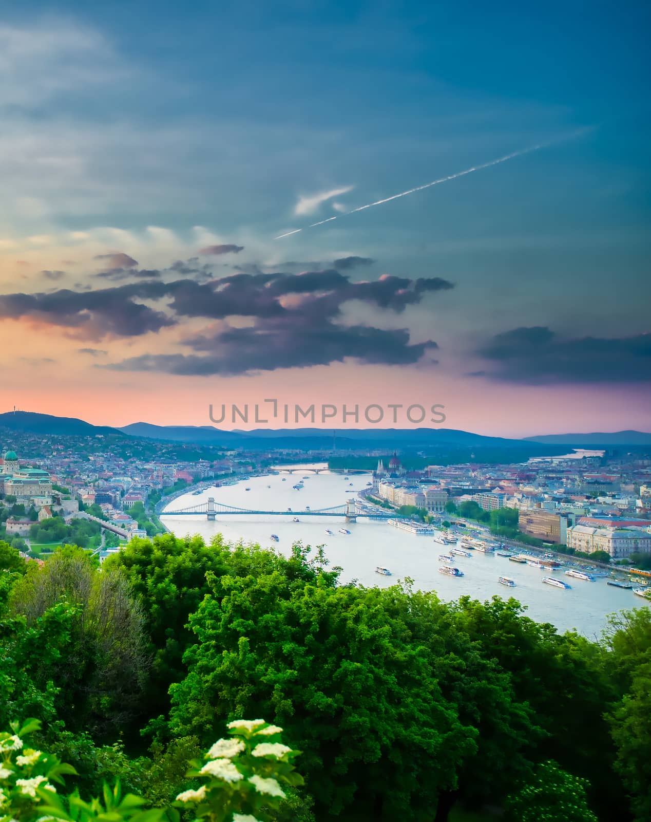 A view along the Danube River of Budapest, Hungary from Gellert Hill at sunset.