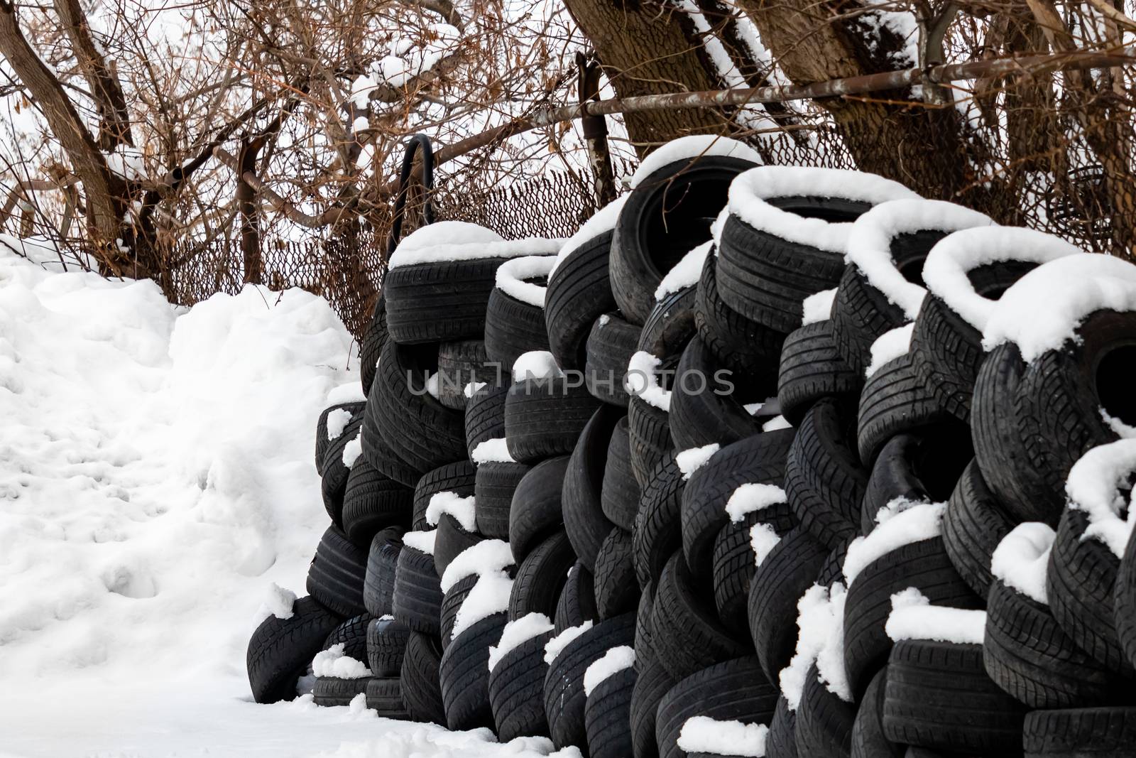 Stacked Tires in the Snow by colintemple