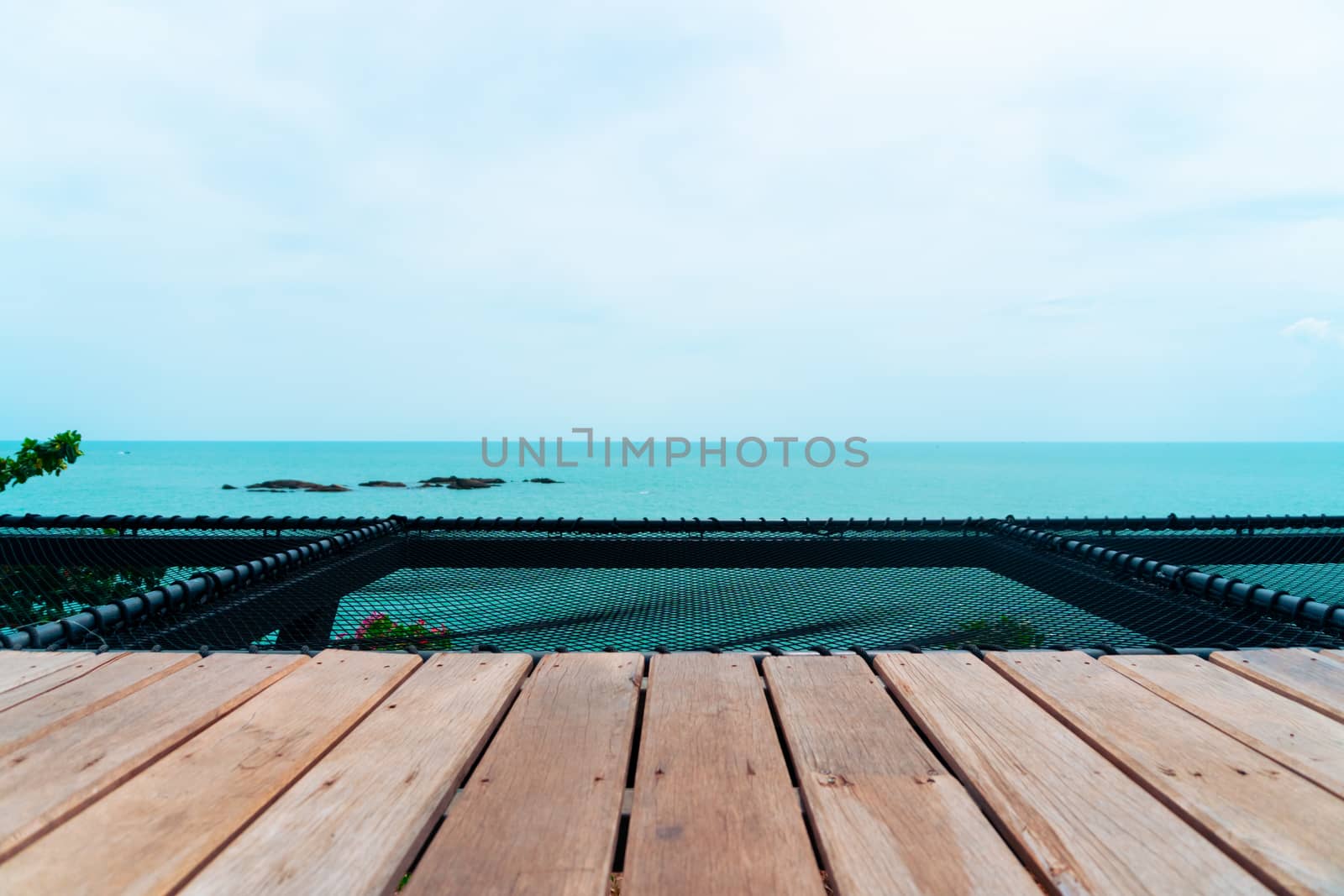 Selective focus of old wood table with blur beautiful beach background for display your product.