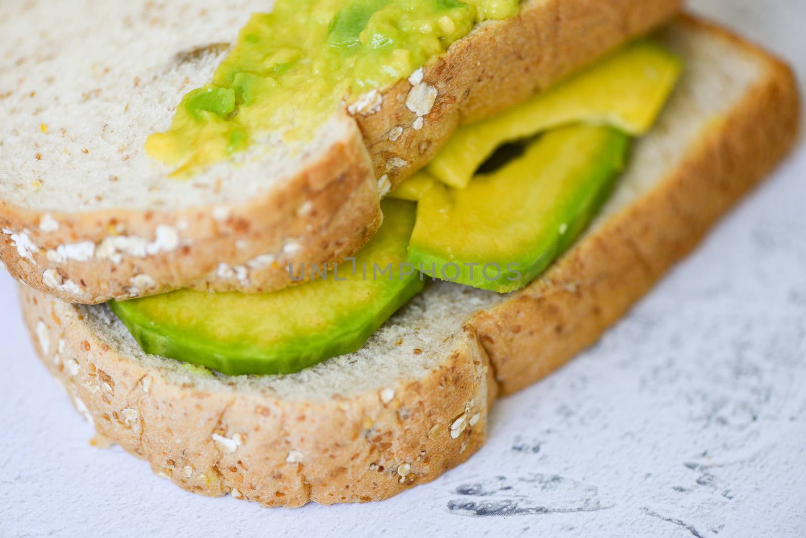 Avocado sandwich and avocado toast on plate background fruits healthy food concept / avocado dip mashed