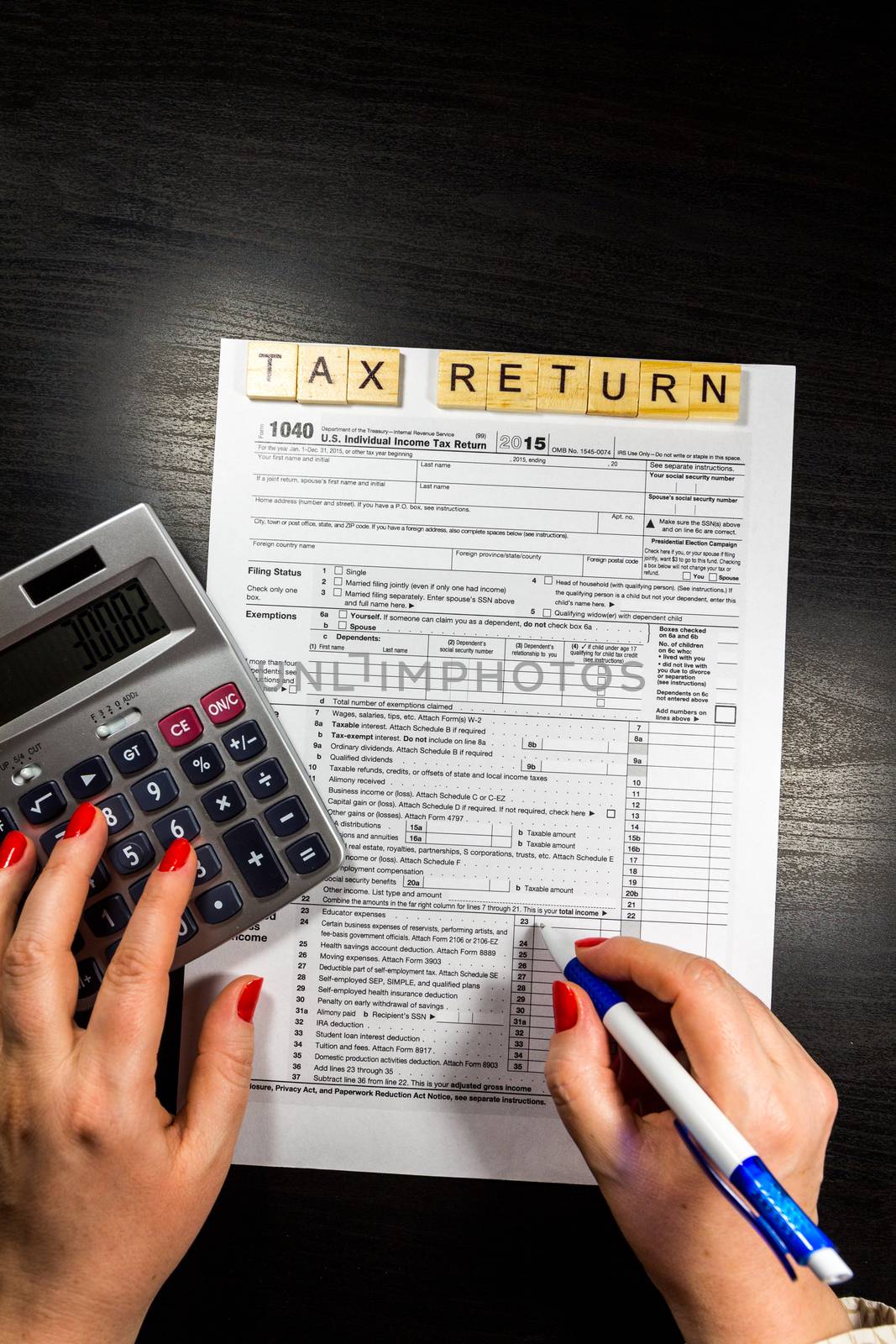 US tax form 1040 with pen and calculator. tax form law document usa white mathematics business concept