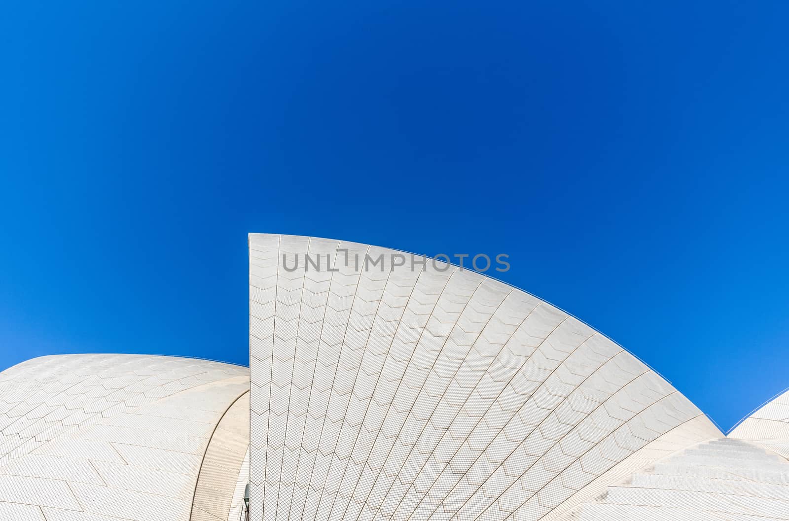 Sydney, Australia - February 11, 2019: Detail of white roof structure of Sydney Opera House against deep blue sky. 1 of 12.