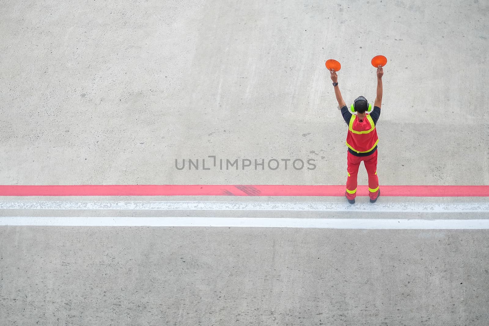 worker holding stop sign by Surasak