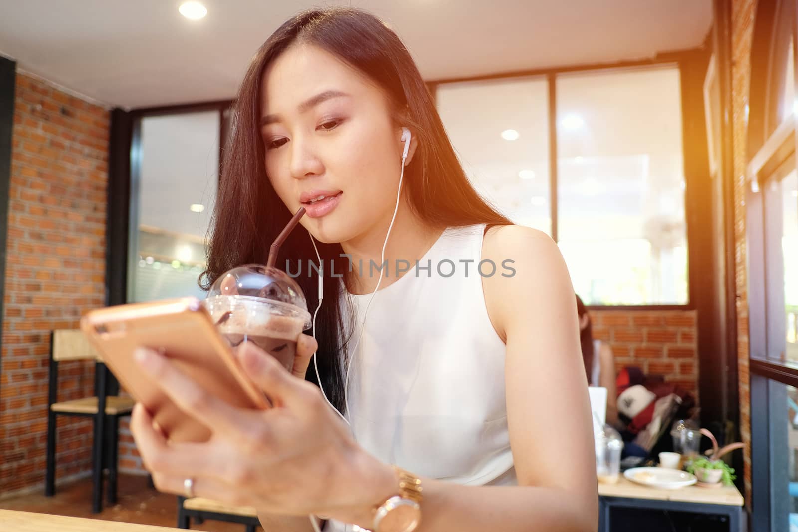 Young woman listening to music in coffee shop