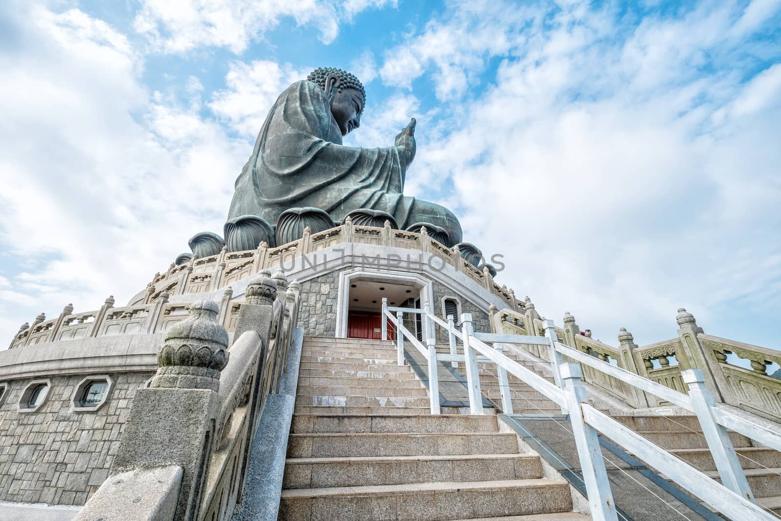 Side View of Tian Tan Giant Buddha in blue sky