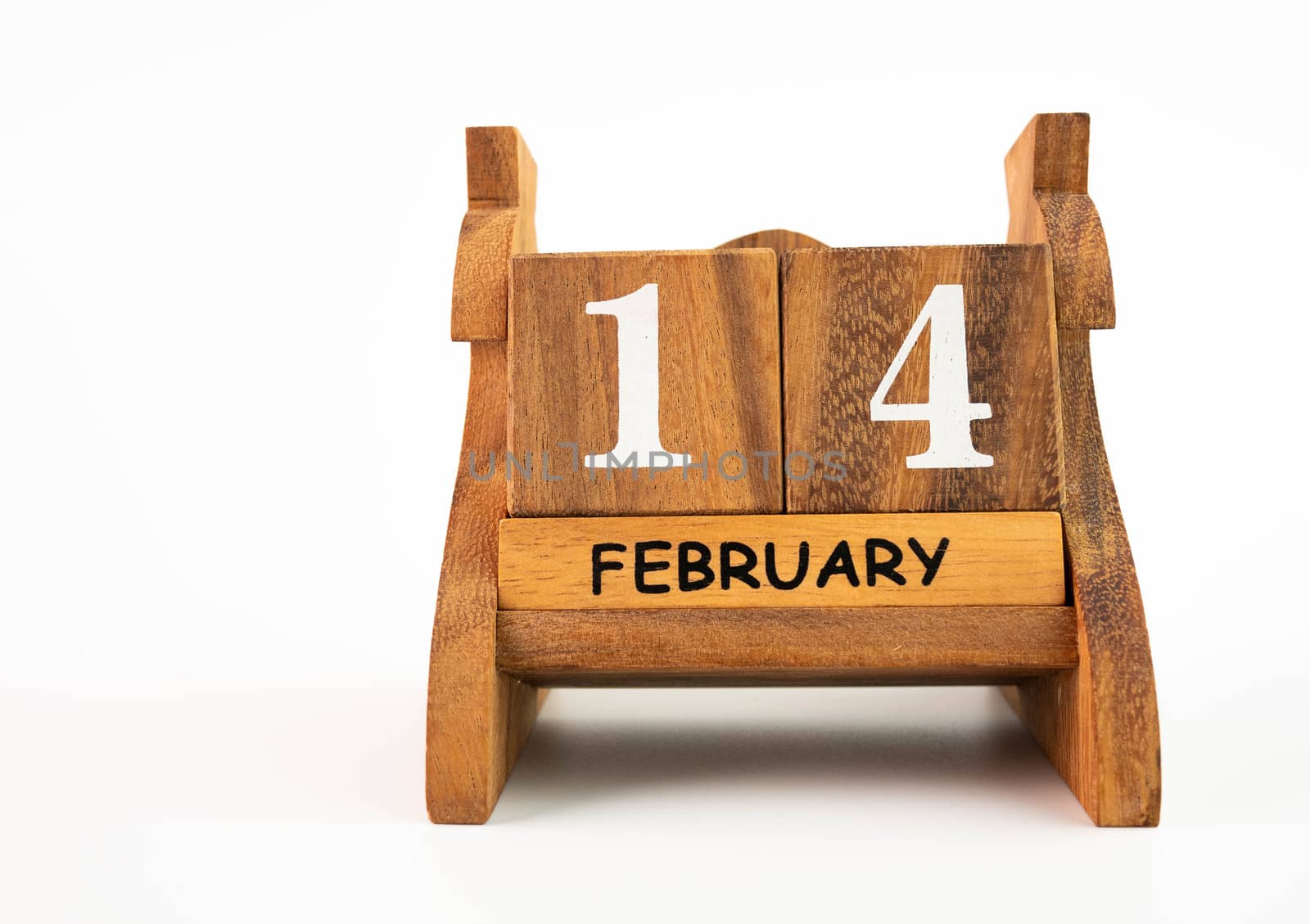 Wooden calendar on February 14 date, isolated on white background. Concept of Valentine's day. by TEERASAK
