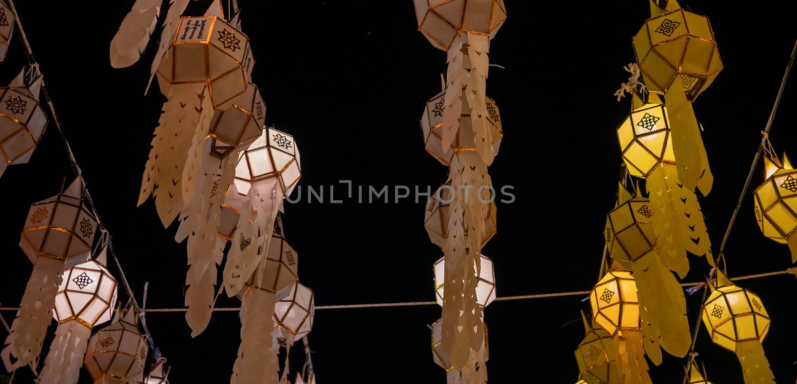 Light from Thai lanna lanterns background at night in Yi Peng Festival. by TEERASAK