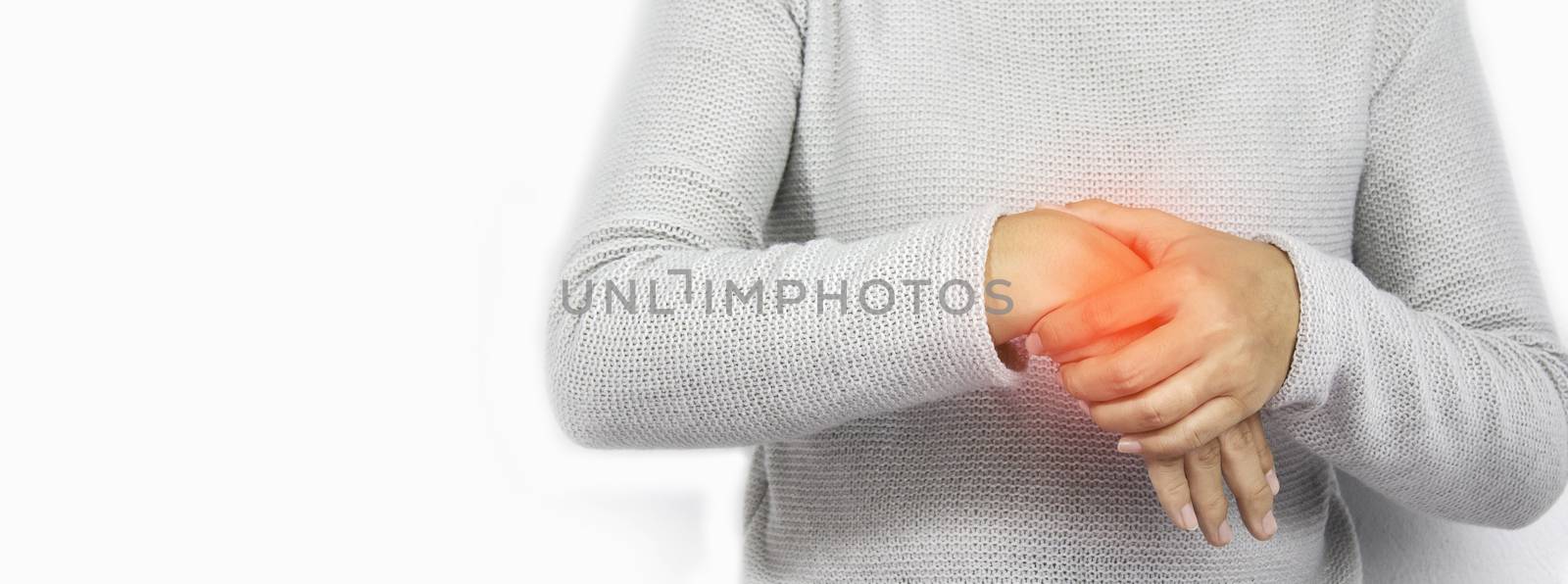 Young women hold her wrist with suffering from arthritis or Carpal tunnel syndrome from work, isolated on white background. by TEERASAK