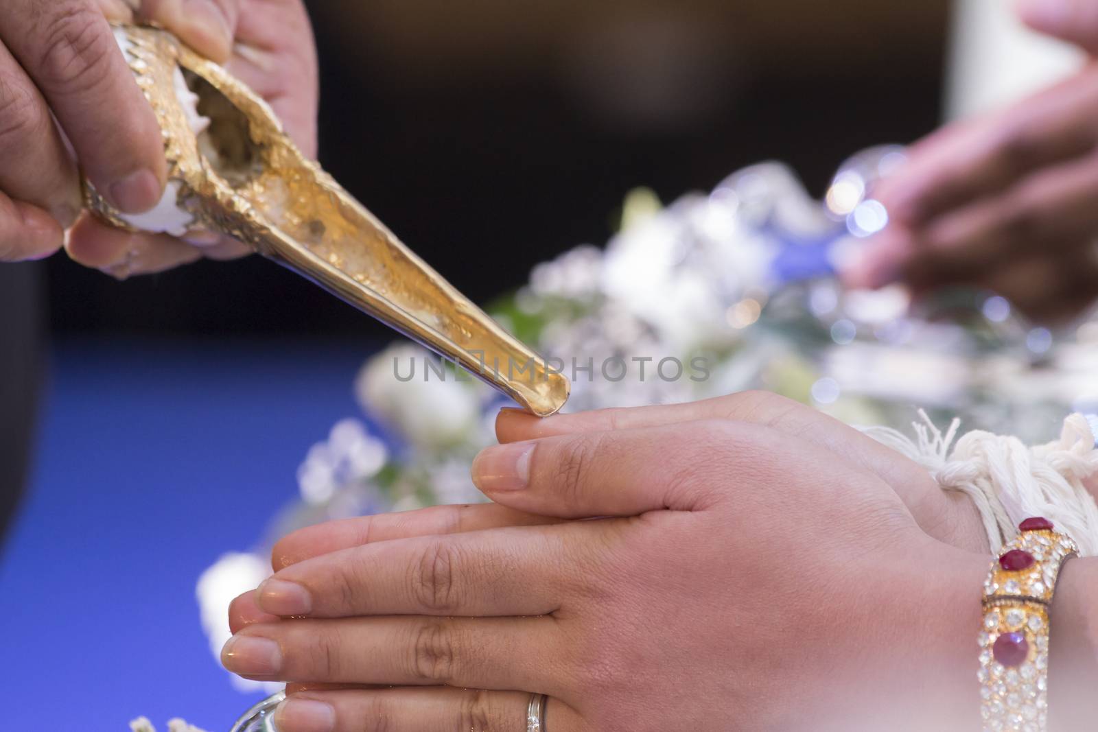 Thai traditional wedding ceremony, water-pouring ceremony on bride's hands