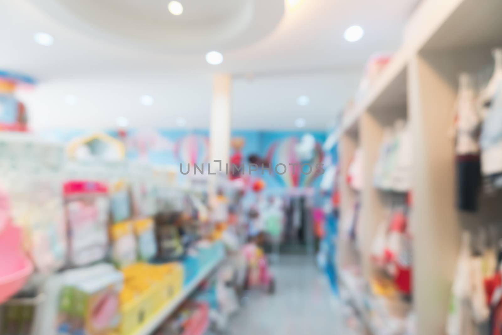 Blur modern baby and kid deparment  store shop bright tone abstract blurry background.