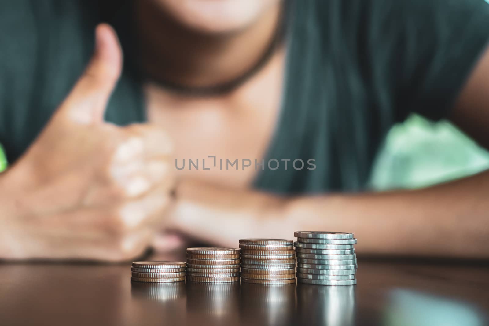 Business financial success concept. Gold coins on table and green nature bokeh background.Bullish market situation.