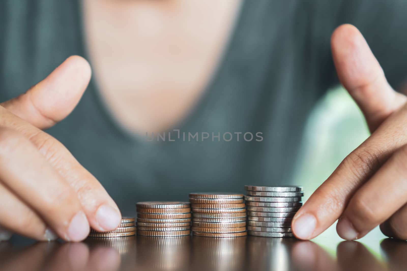 Business financial success concept. Gold coins on table and green nature bokeh background.Bullish market situation.