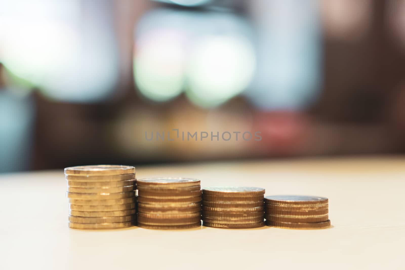 Business financial success concept. Gold coins on table and green nature bokeh background.Bullish market situation.