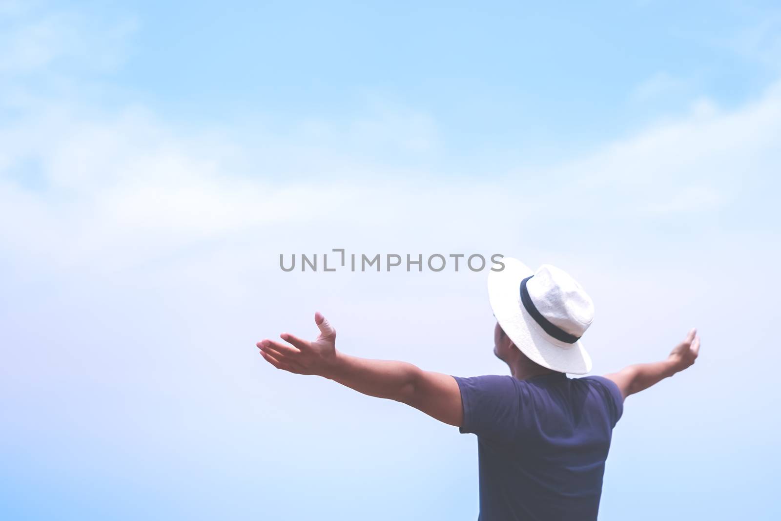 Man rise hands up to sky freedom concept with sunset sky and summer beach background.