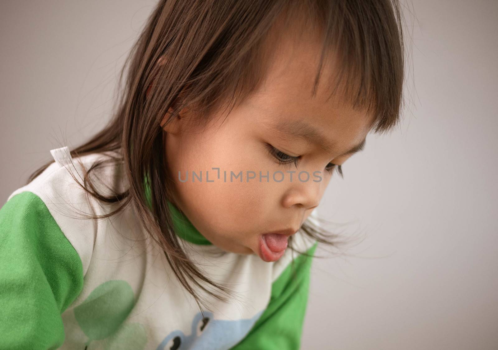 Cute little girl coughing isolated on gray background. Concept o by TEERASAK