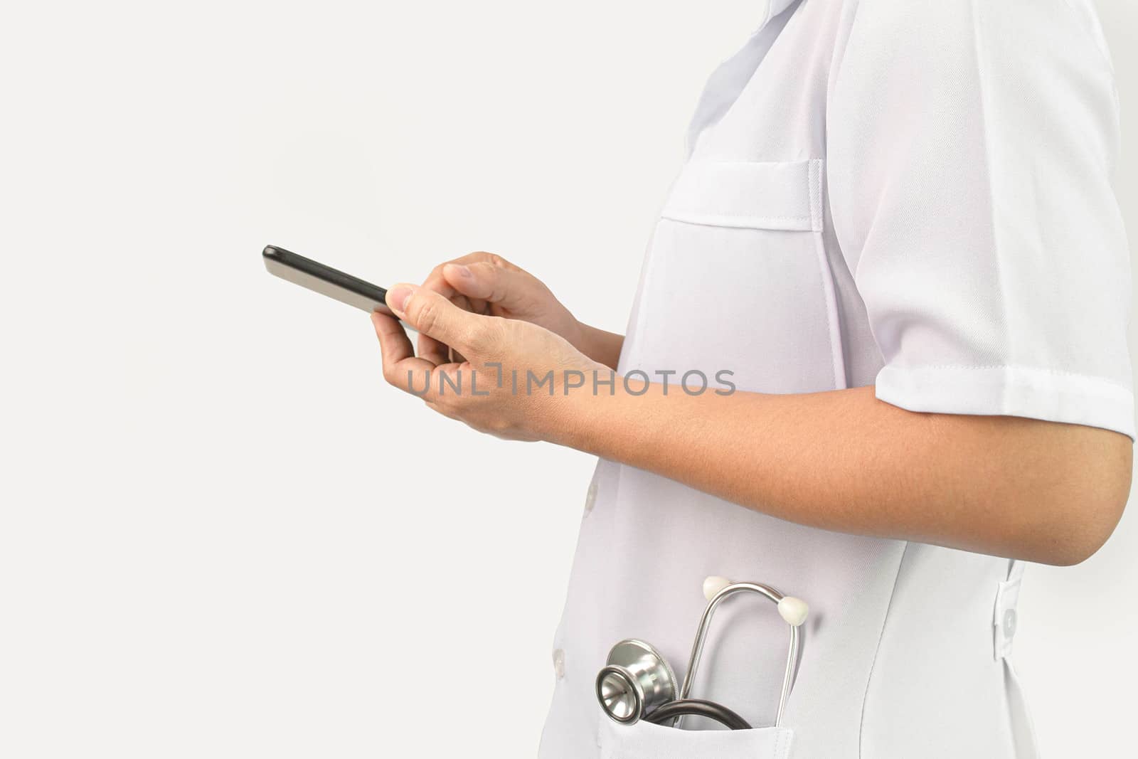 Confident young woman doctor using smartphone with stethoscope i by TEERASAK