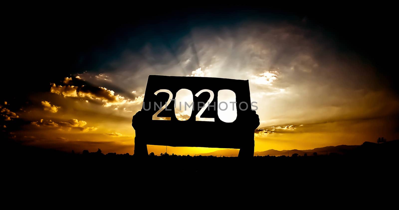 Silhouette of hands holding recycle cardboard with 2020 text ove by TEERASAK