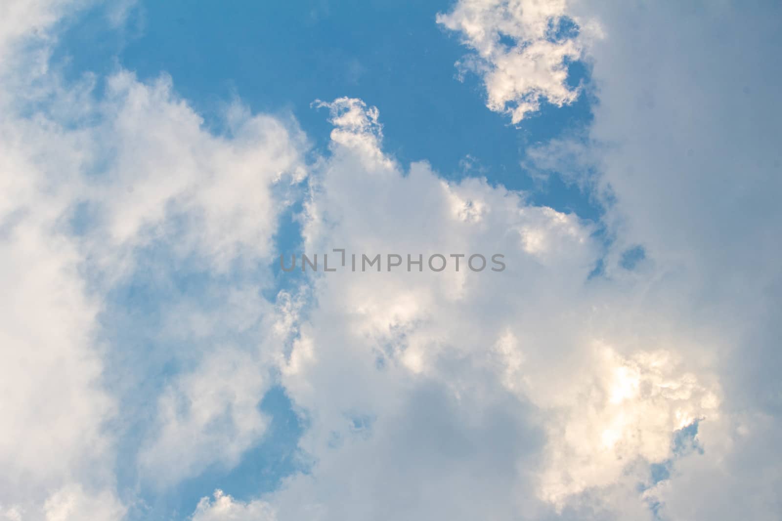Blue sky with white clouds on hot summer day. Nature background.