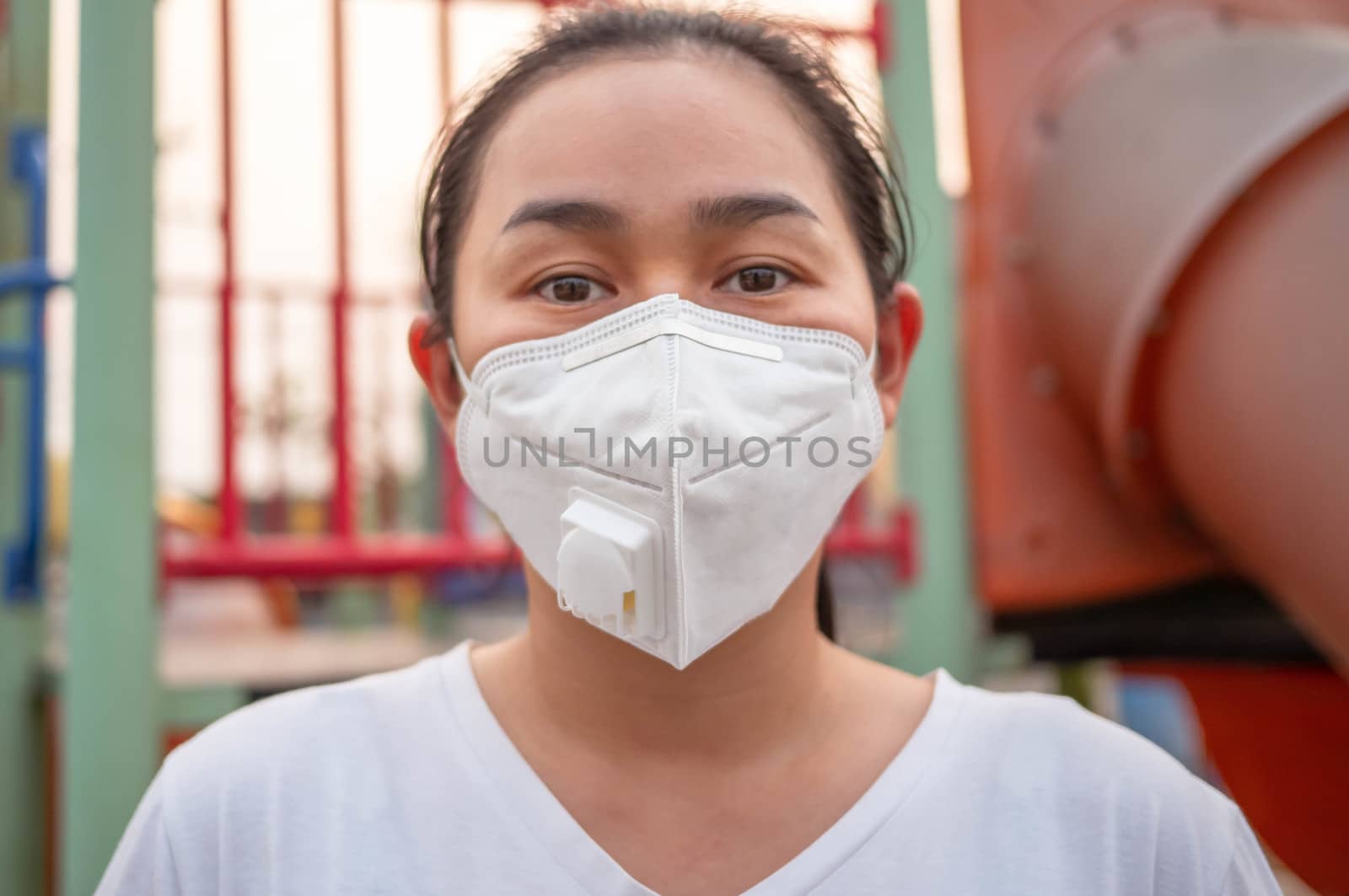 Asian woman wearing facial mask for protection from air pollution or virus epidemic when stay outdoors. Health care concept.
