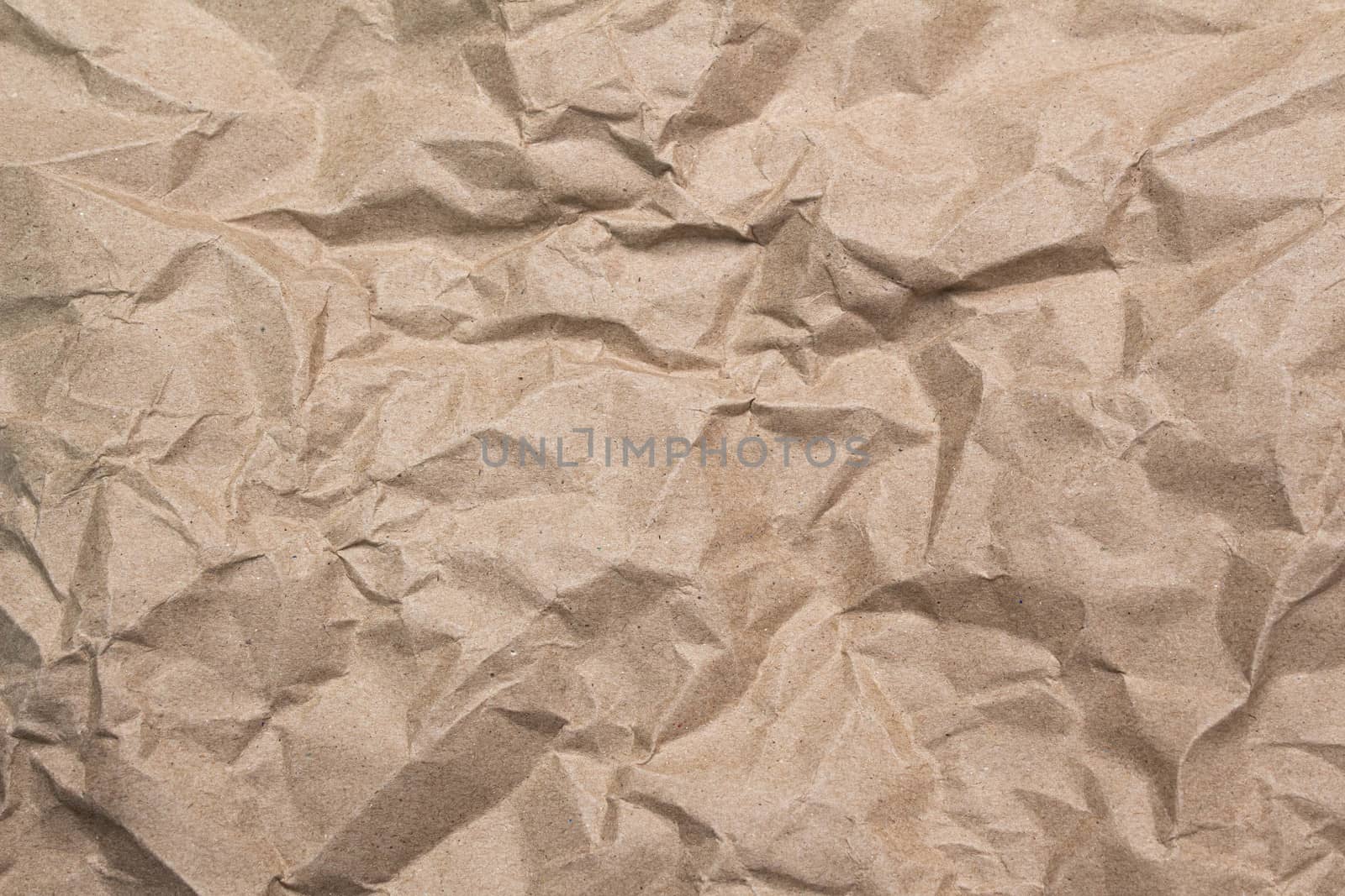Close up of brown crumpled paper texture background. by TEERASAK