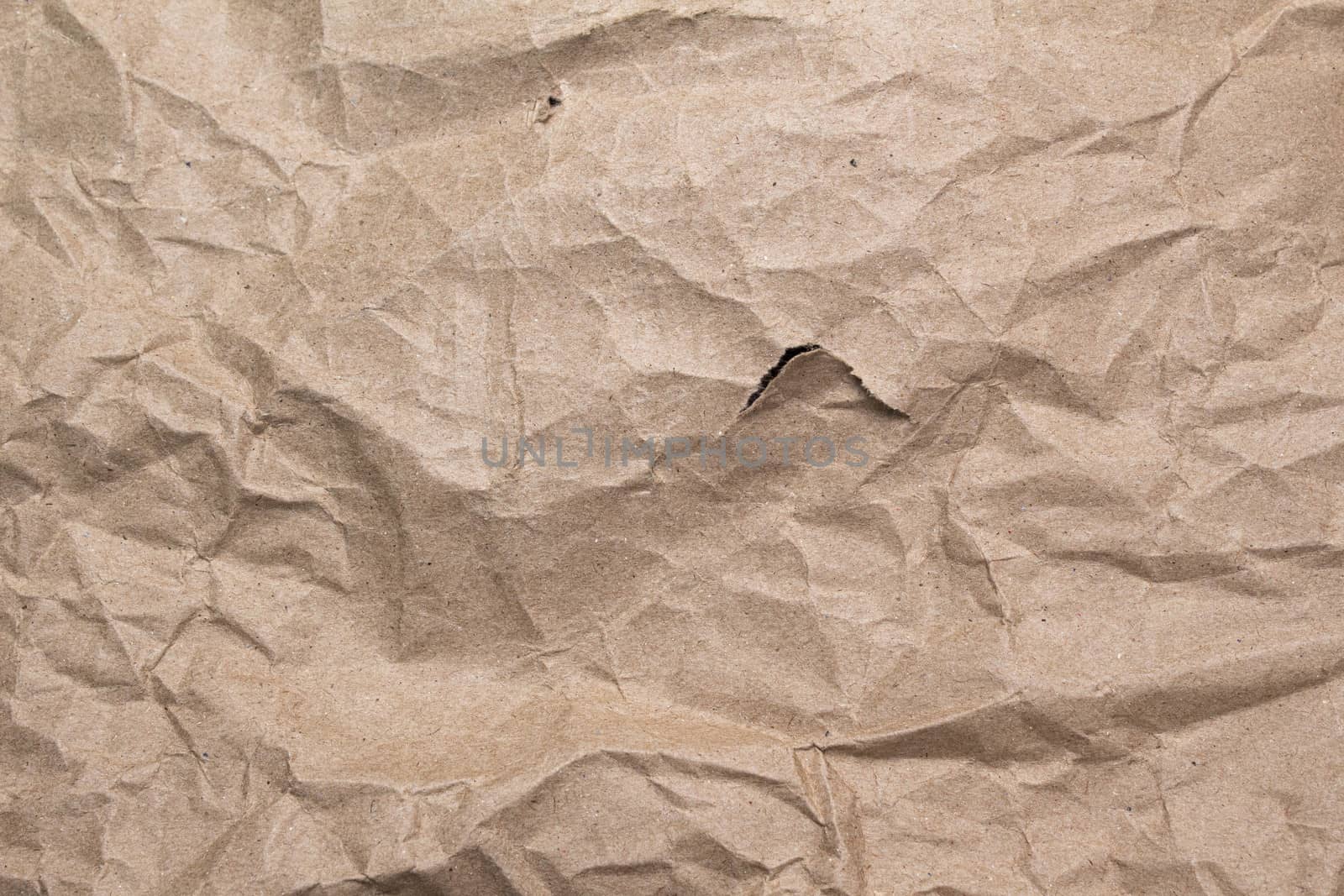 Close up of crumpled brown paper texture and torn.