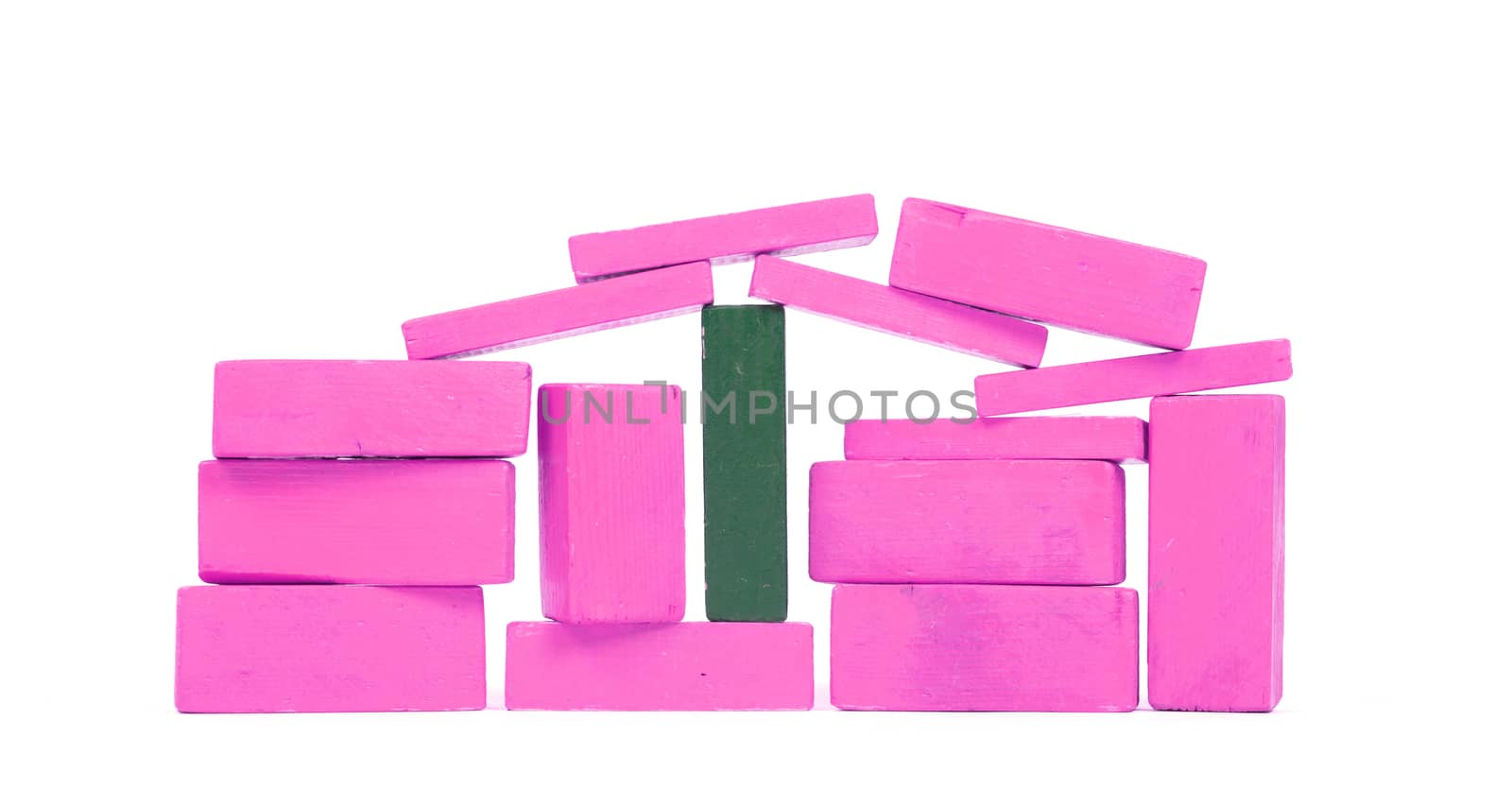 Vintage pink building blocks isolated on white background, one green one