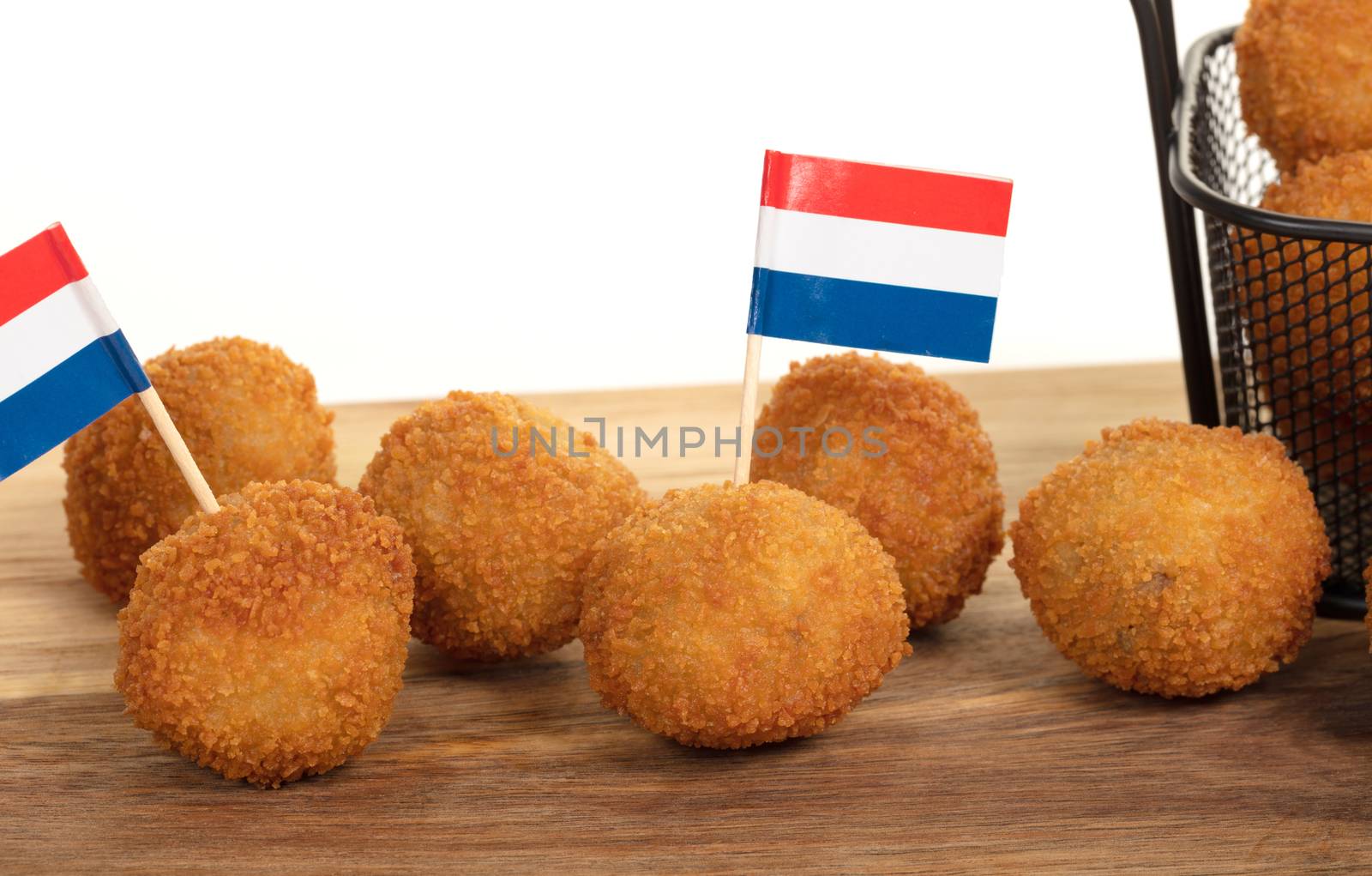 Dutch traditional snack bitterbal on a serving board, dutch flag, isolated