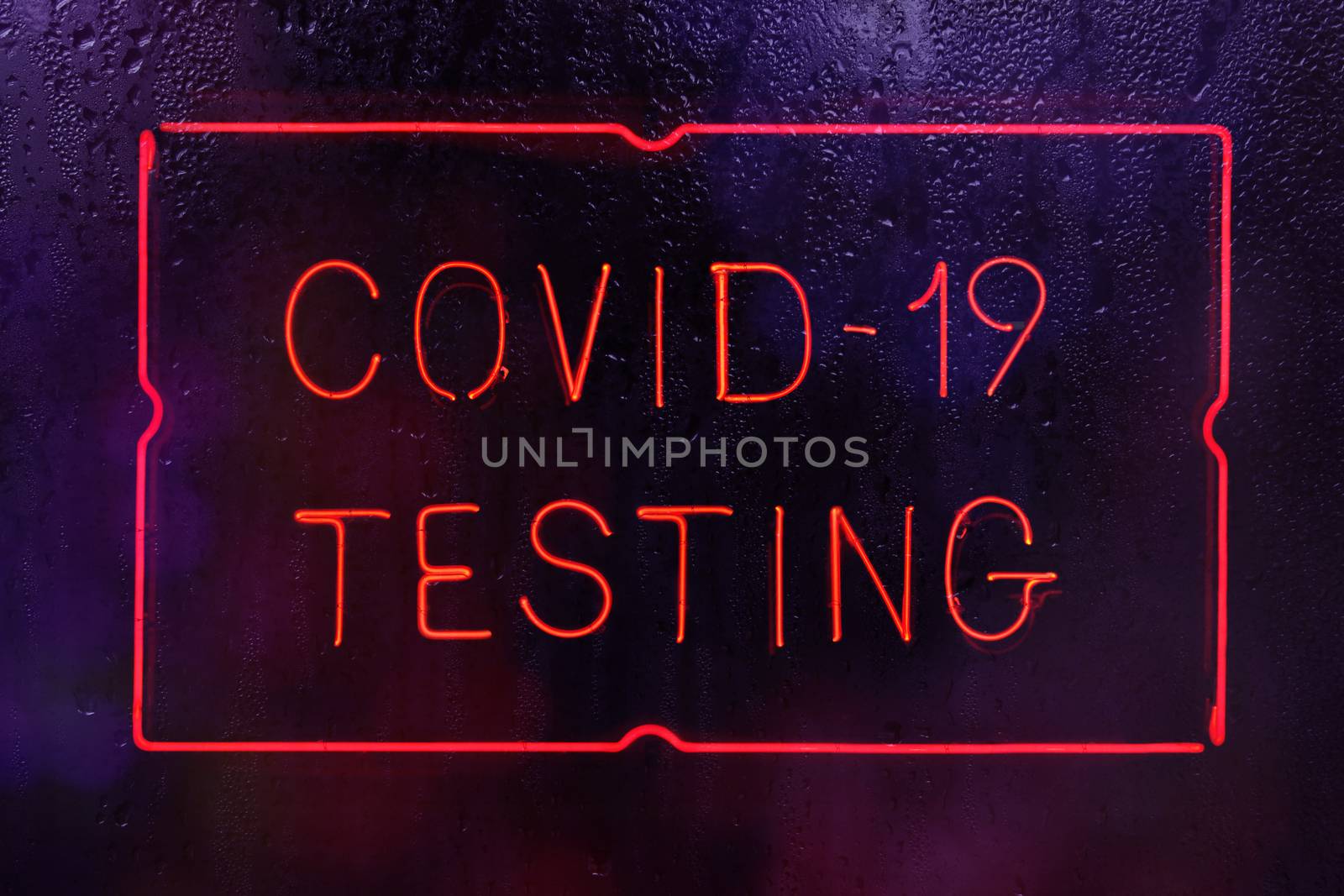 Covid-19 Testing Neon Sign in Rainy Window by Marti157900