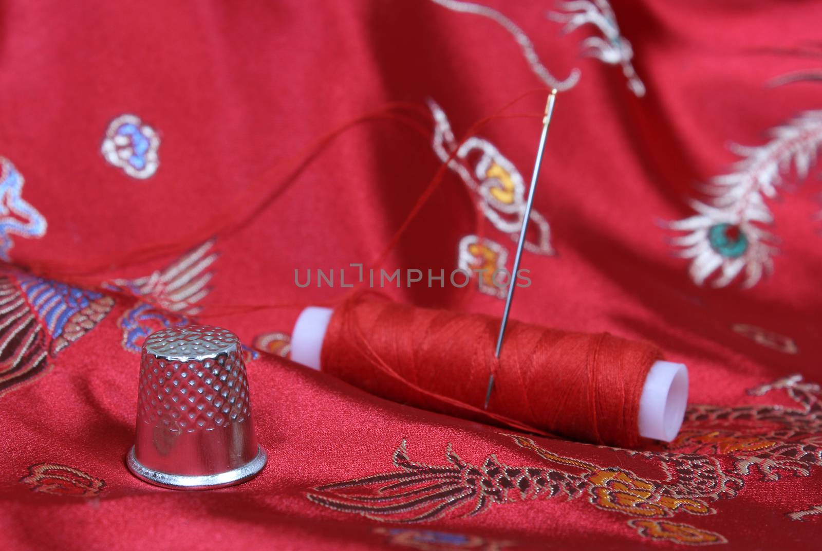 Thimble and Thread on Asian Red Silk Fabric Shallow DOF