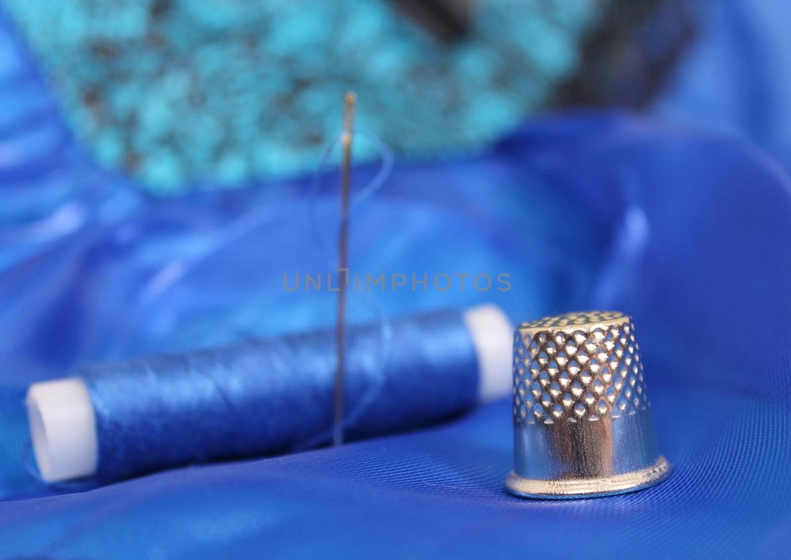 Blue Thread with needle and thimble on blue prom dress by Marti157900