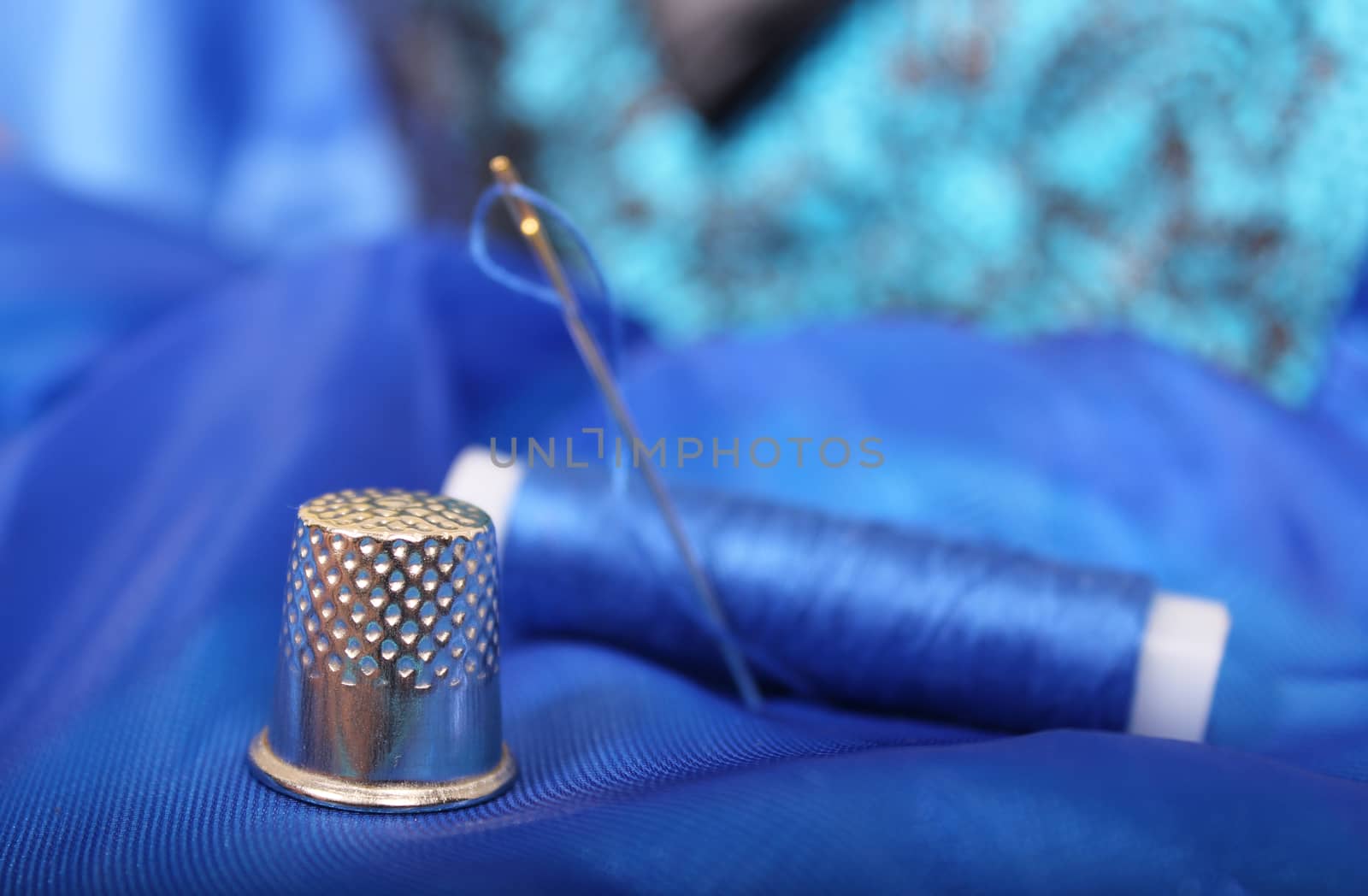 Thimble and Blue Thread on Blue Fabric Shallow DOF