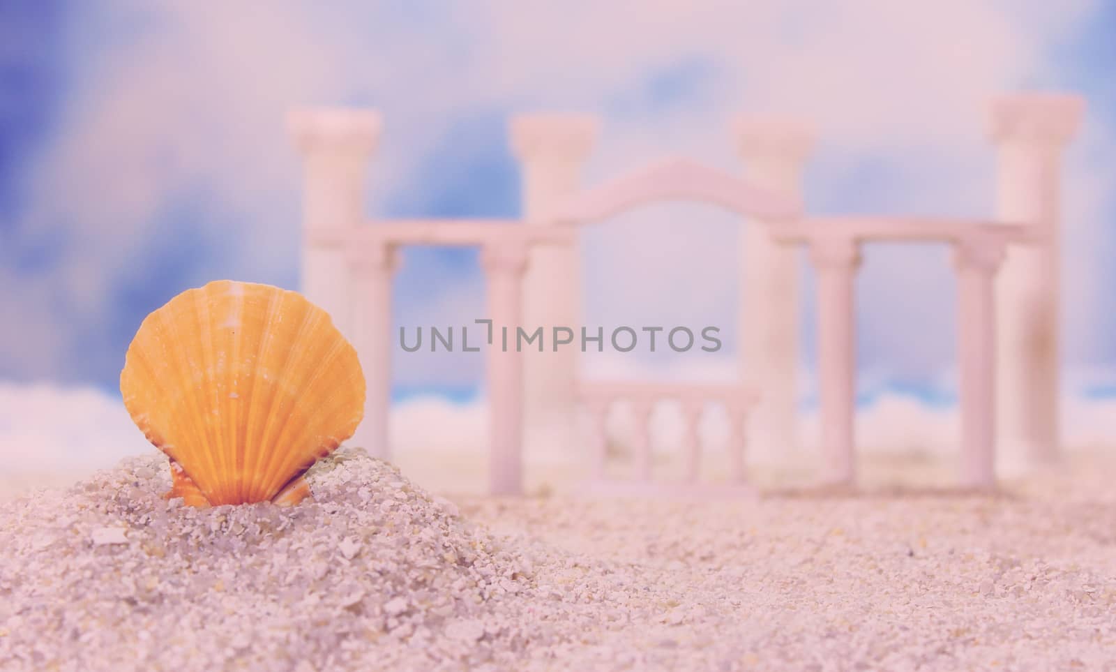 Seashell on Tropical Beach With Roman Style Ruins Shallow DOF, Focus on Shell