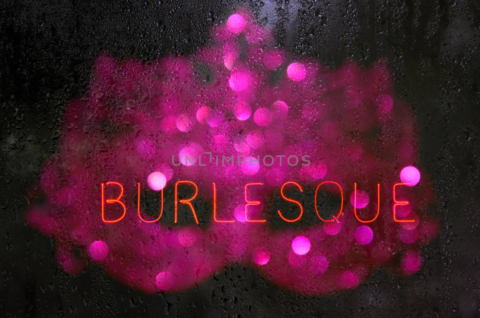 Vintage Neon Burlesque Sign in Wet Window