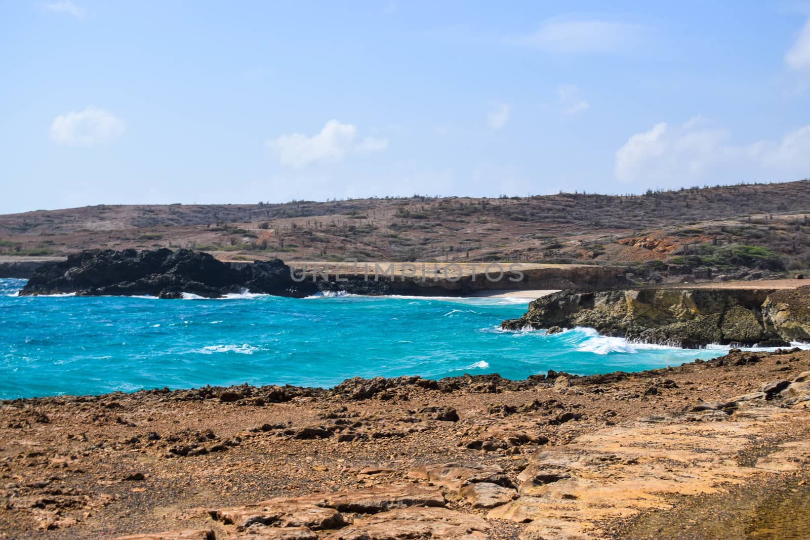 Arikok Natural Park on the island of Aruba in the Caribbean Sea with deserts and ocean waves on the rocky coast