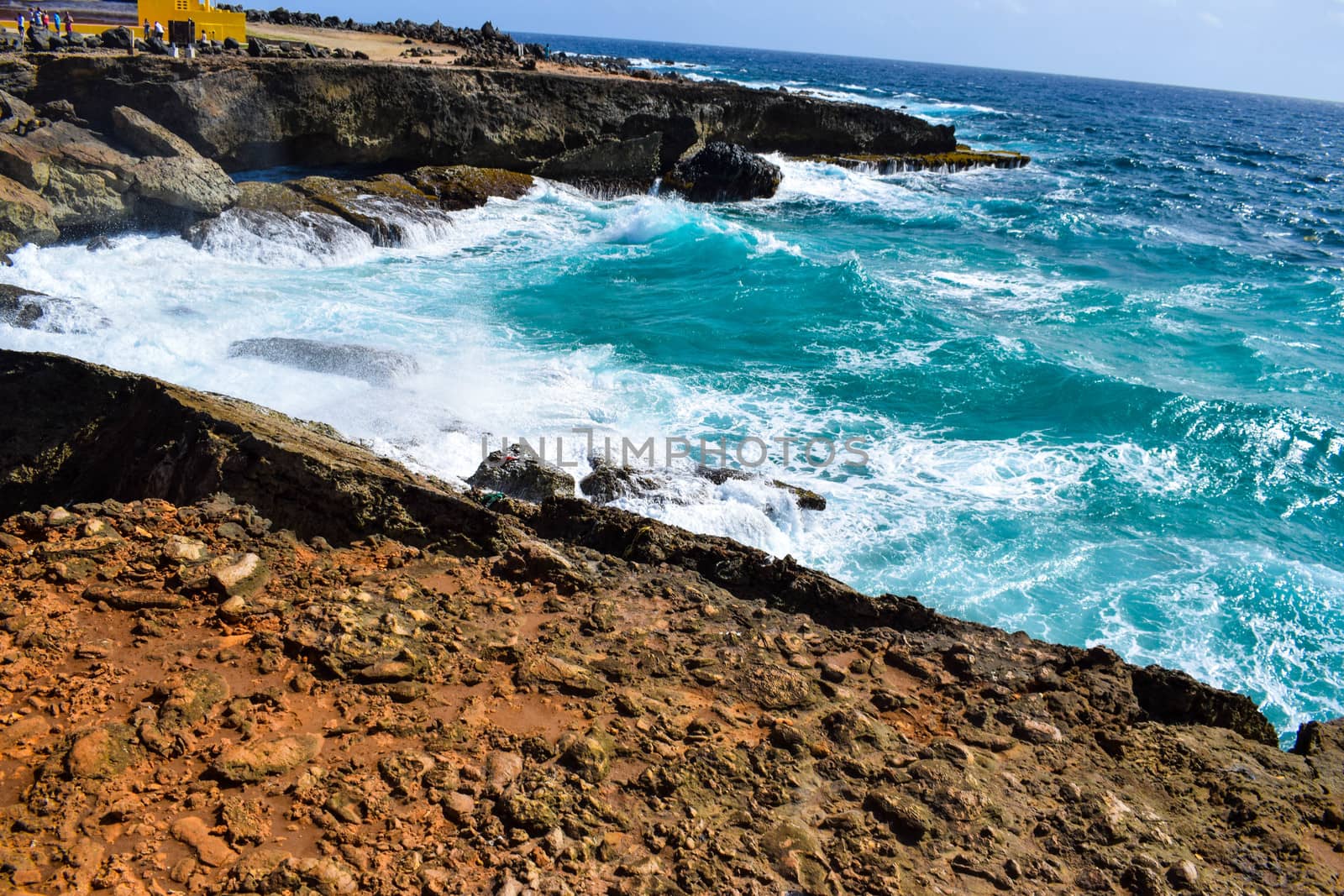 Arikok Natural Park on the island of Aruba in the Caribbean Sea with deserts and ocean waves on the rocky coast