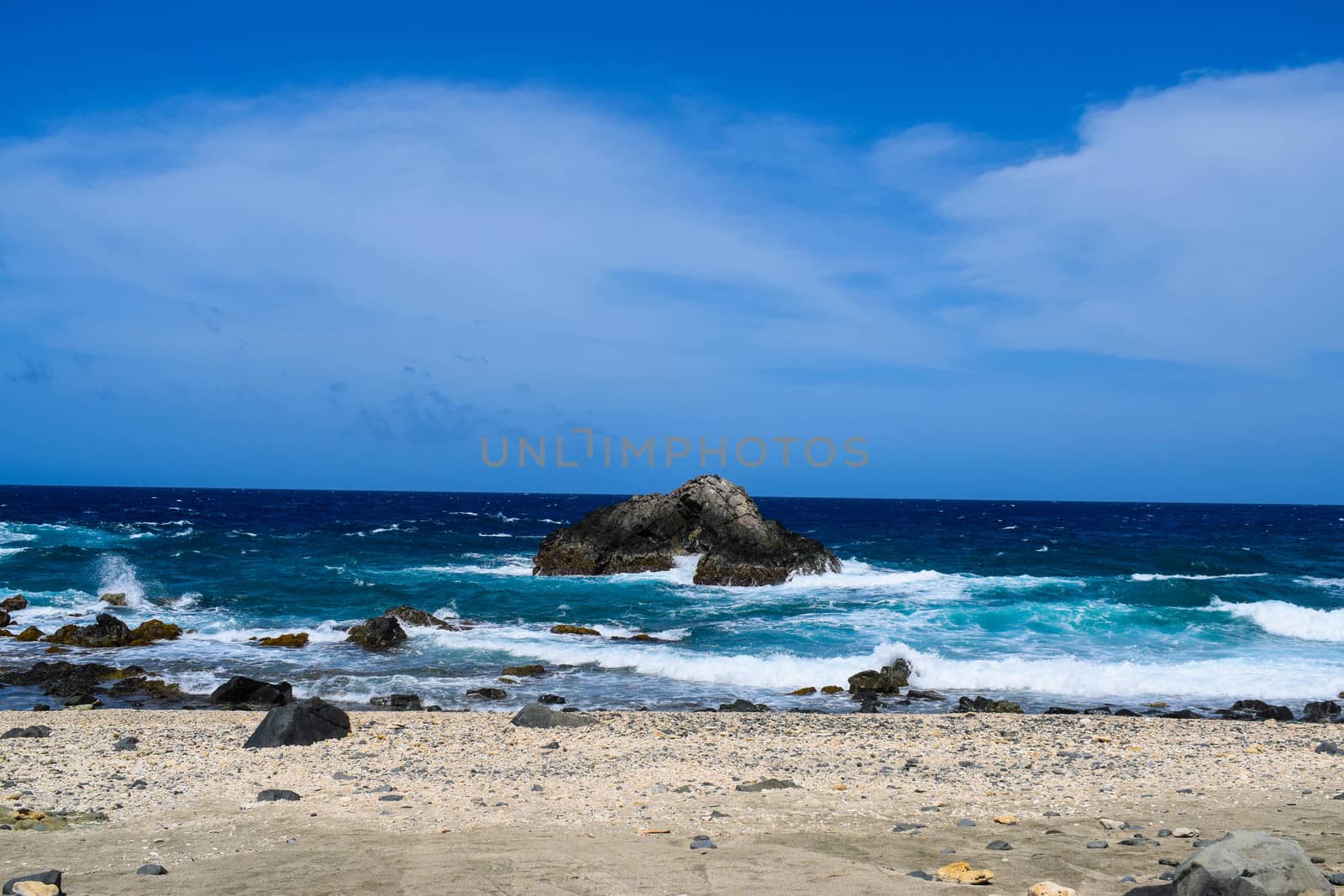 Arikok Natural Park on the island of Aruba in the Caribbean Sea with deserts and ocean waves on the rocky coast