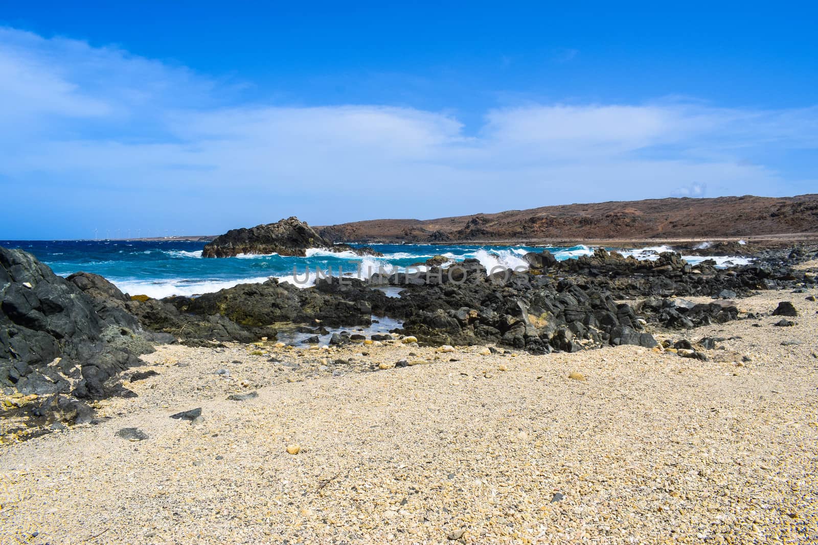 Arikok Natural Park on the island of Aruba in the Caribbean Sea with deserts and ocean waves on the rocky coast